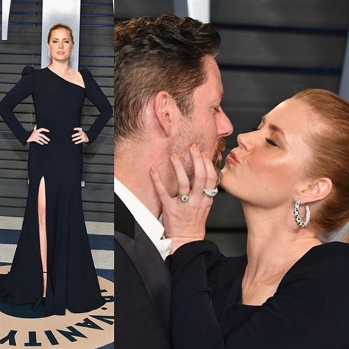 Amy Adams in Christian Siriano playfully kisses husband Darren Le Gallo